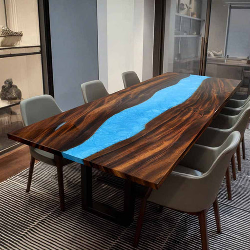 Close-up of walnut wood grain and vibrant blue epoxy resin craftsmanship