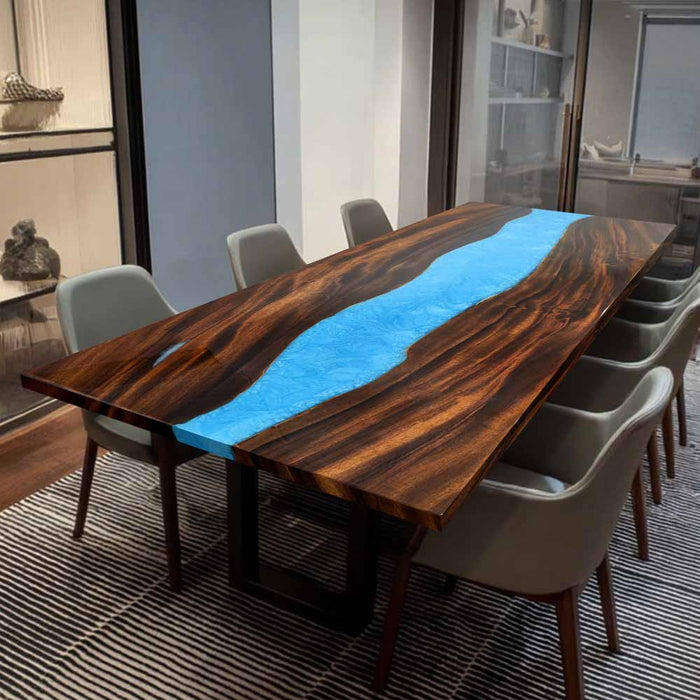 Close-up of walnut wood grain and vibrant blue epoxy resin craftsmanship