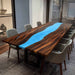 Close-up of walnut wood grain and vibrant blue epoxy resin craftsmanship