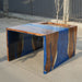 Walnut waterfall table featuring vibrant blue epoxy resin