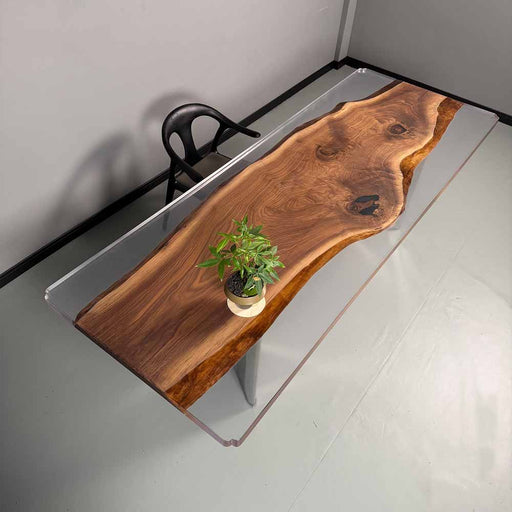 Wooden desk with clear acrylic base in a minimalistic room