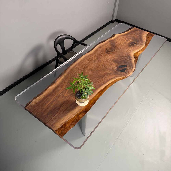 Wooden desk with clear acrylic base in a minimalistic room