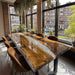 Close-up of a live edge walnut dining table with a clear epoxy resin river.