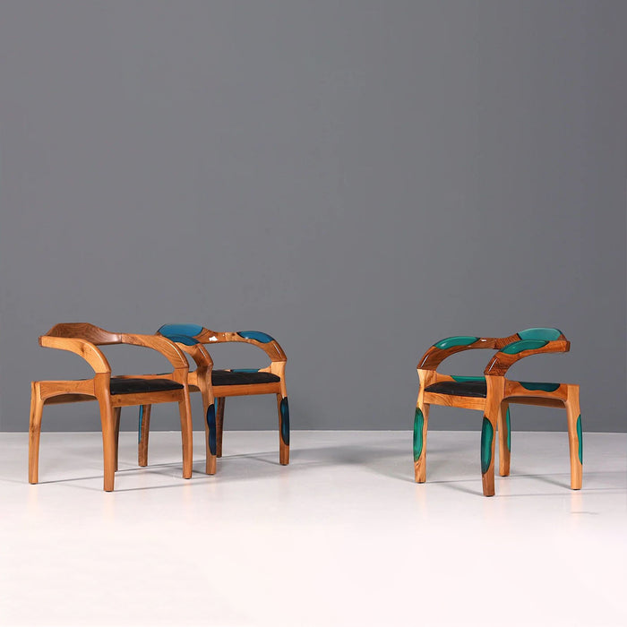 Two wooden chairs with green and black accents on a gray background