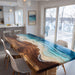 Artistic walnut epoxy table showcasing ocean-blue resin, flowing waves, and a smooth sand beach pattern.