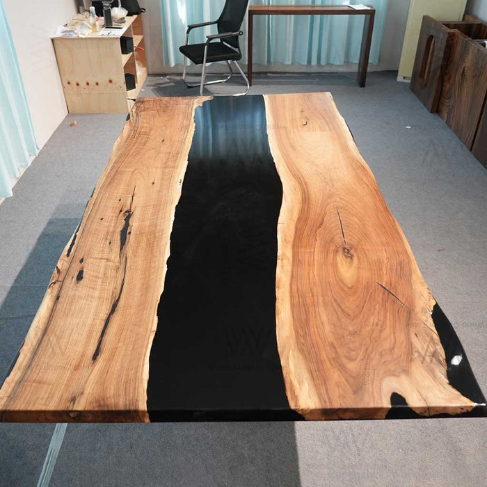 Walnut epoxy river table black resin centerpiece in farmhouse dining space