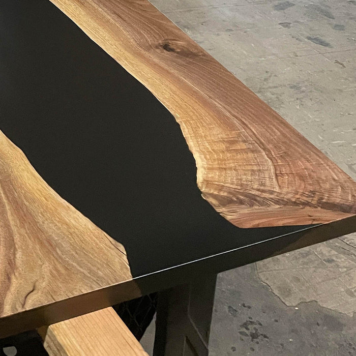 Live edge walnut epoxy resin table comfortably seating six people.