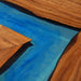 Walnut bar or kitchen countertop featuring mysterious blue epoxy resin river