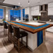 Modern kitchen with a large island featuring a blue accent