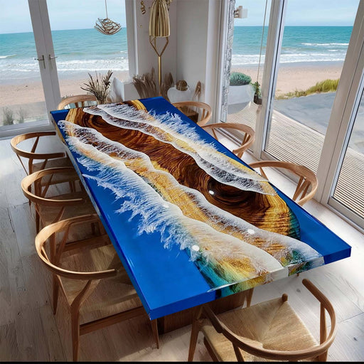 Dining table with a unique ocean-themed design in a room with large windows showing a beach view.
