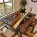 Handcrafted epoxy table showing floral resin river design with natural walnut grain texture