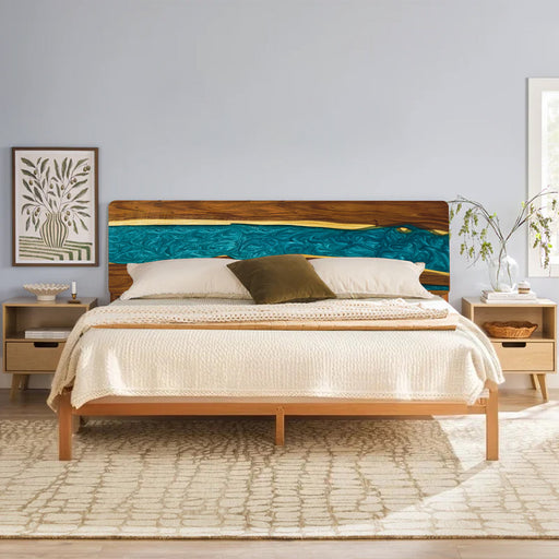 Wooden bed with a decorative headboard in a bedroom setting