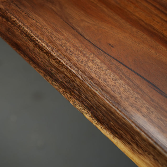 Close-up of a wooden surface with a dark brown finish