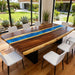 Wooden dining table with blue river design in a modern indoor setting