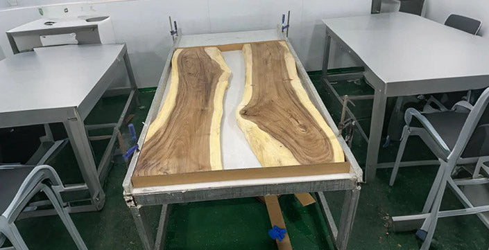 Wooden table with a river design in a classroom setting