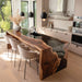 Modern kitchen with a long wooden dining table and chairs.