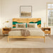 Wooden bed with green accent in a bedroom setting