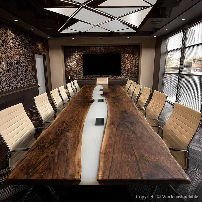 White resin river conference table featuring built-in power outlets for office use and device charging.