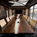 White resin river conference table featuring built-in power outlets for office use and device charging.