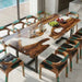 Dining table with natural wood design and matching chairs in a modern setting.