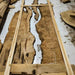 Wooden slabs with a natural, rough texture on a white floor.
