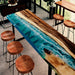 Handcrafted ocean-themed resin high table with wood base and stools, ideal for coastal homes or cafes.